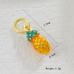 Detail showing 1.6cm 18k gold-plated pineapple charm with vibrant yellow and green enamel