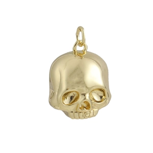 Close-up of polished 18k gold plated skull pendant with mirror-like metallic finish