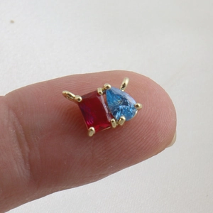 Detail of mini square and pear-shaped colorful zircon pendant with 18k gold plating