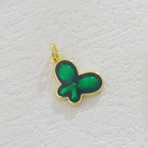 Detail of 18k gold butterfly pendant with green enamel inlay for jewelry making