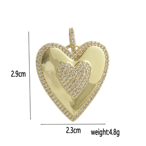 Detail view of 18k gold heart pendant with dimensions showing 2.9cm height and 2.3cm width