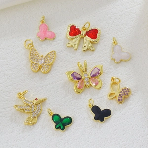 Detailed view of colorful enamel butterfly pendants in 18k gold plating for DIY jewelry