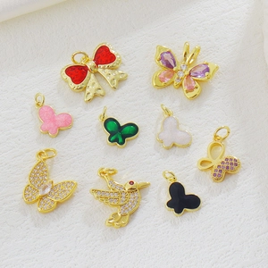 Detail of 18k gold-plated butterfly and hummingbird charms for DIY jewelry making