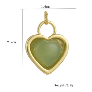 Detailed view of gold heart pendant with green stone, measuring 1.6cm by 2.2cm height