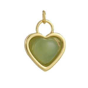 Detail of a heart-shaped gold-plated pendant featuring a translucent green stone inlay