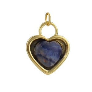 Detailed macro view of heart-shaped gold pendant with blue stone inlay for jewelry
