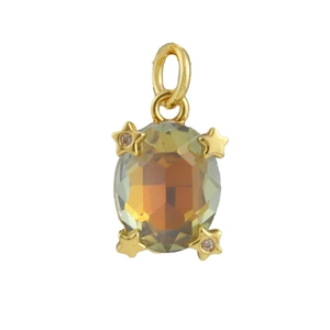 Macro view of gold evil eye pendant with star-shaped prongs and amber oval gemstone
