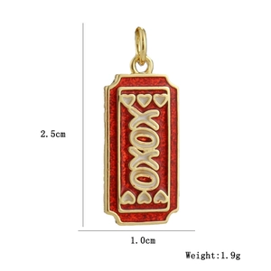 Detail of 18k gold plated camera pendant with red enamel XOXO design and top loop