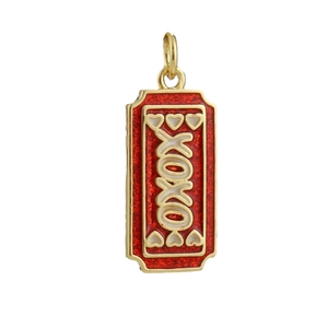 Macro detail of a gold-plated camera pendant with red glitter enamel and XOXO text