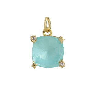 Macro shot of cushion cut light blue zircon pendant with gold star detailing