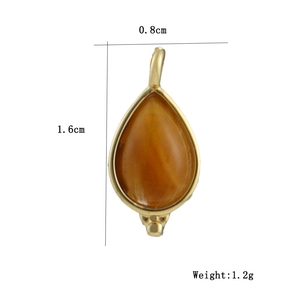 Detail view of water drop amber zircon pendant with dimensions 0.8cm x 1.6cm and weight 1.2g