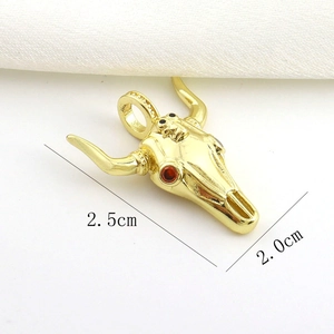 Detailed macro view of gold-plated bull skull pendant with size measurements