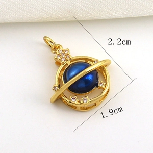 Detail of gold Saturn pendant with blue opal pearl and zircon stones, 2.2cm x 1.9cm
