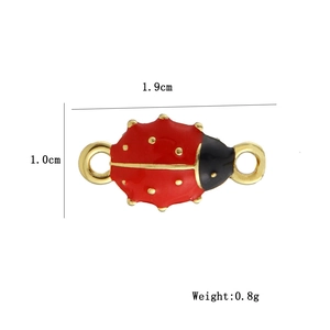 Detailed view of red ladybug connector charm in 18k gold plating with enamel finish