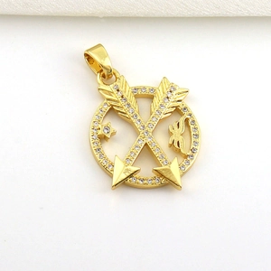Detailed macro view of 18k gold plated round charm with arrow design and white zircons