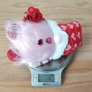 Detailed view of 112.7g Valentine gnome plush with red roses on a digital kitchen scale