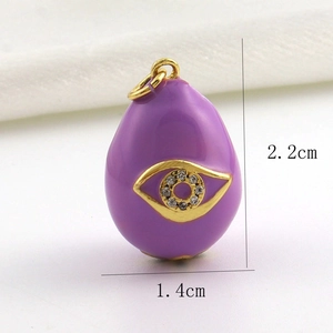 Detail of 18k gold plated purple enamel egg pendant with evil eye and zircon inlay