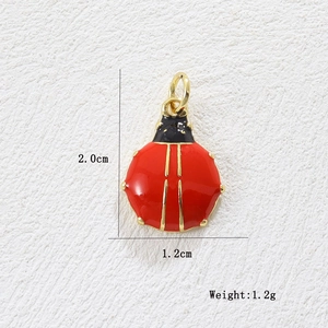 Detail view of red ladybug pendant with 18k gold plating showing 2.0cm length dimensions