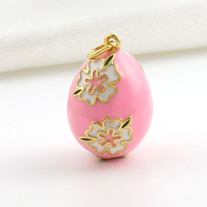 Detail of pink enamel Faberge style egg pendant with white cherry blossom motifs