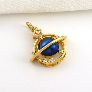Macro shot of 18k gold-plated Saturn pendant with deep blue bead and star accents