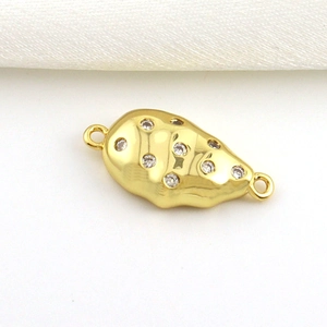 Detail of 18k gold plated organic shape jewelry connector with sparkling zircon stones