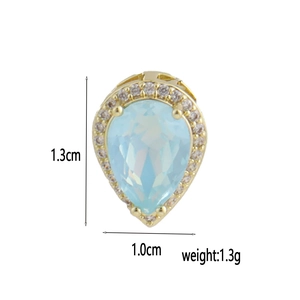 Detailed view of teardrop pendant with blue gemstone and white zircon in 18k gold plating