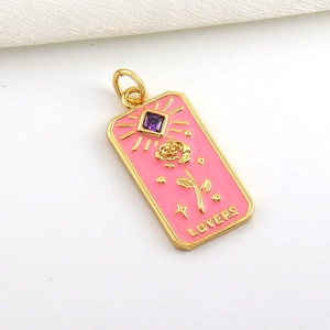 Detail of 18k gold plated Tarot Lovers charm with pink enamel, rose, and purple zircon