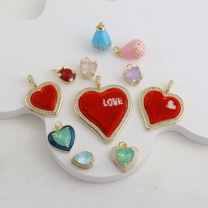Detail of DIY heart charms with red flocking and colorful gemstones for necklaces