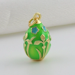 Detail van een groene emaille eivormige hanger met gouden bloemmotieven in Fabergé-stijl