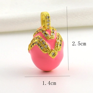 Macro detail of pink enamel Easter egg pendant with gold wavy lines and cubic zirconia