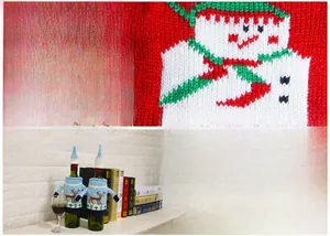 Detail of knitted Christmas wine bottle covers with snowman and reindeer patterns