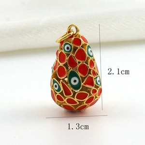 Macro shot of gold-plated evil eye egg pendant with 2.1cm height and enamel details