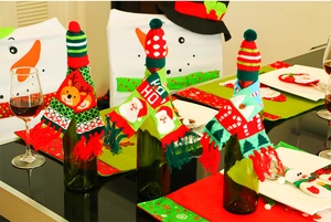 Close-up of knitted Christmas wine bottle set with Santa, reindeer and candy cane motifs