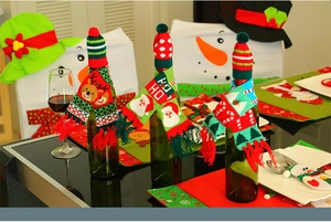 Close-up of festive knitted Christmas wine bottle set with Santa and reindeer patterns
