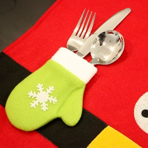 Green mitten Christmas cutlery holder with white snowflake and plush trim for table decor