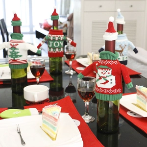 Festive knitted Christmas wine bottle covers with mini hats featuring snowman and deer