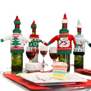 Festive knitted Christmas wine bottle covers featuring snowman, reindeer and tree patterns