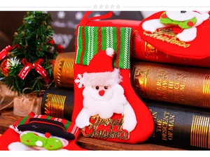 Detail of red Christmas stockings featuring Santa and Snowman with Merry Christmas text
