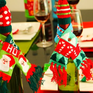 Knitted Christmas wine bottle covers with mini hats and scarves featuring festive patterns