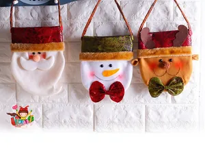 Detailed close-up of Santa, Snowman, and Reindeer Christmas gift bags with bow accents
