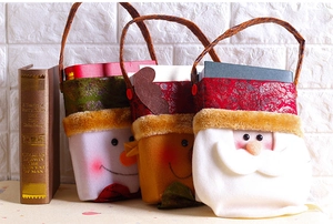 Three festive Christmas gift bags with snowman, reindeer, and Santa Claus characters