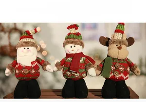 Detailed close-up of plush Christmas dolls including Santa, snowman and reindeer figures