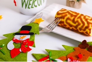 Detail of Christmas tree shaped cutlery holder with festive snowman and reindeer design