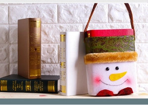 Detailed view of plush snowman Christmas gift bag with books in festive scene