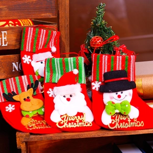 Christmas stockings set with Santa, Snowman and Reindeer hanging on a wooden frame