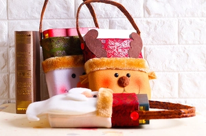Detail showing plush Christmas gift bags with snowman and reindeer character designs
