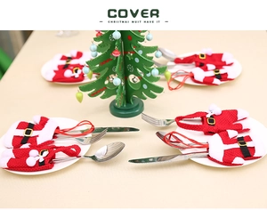 Detail of red and white knitted Christmas tree cutlery holders for festive table decor