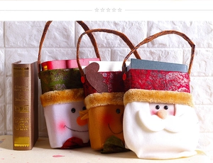 Detailed view of plush Christmas gift bags featuring Santa, reindeer, and snowman designs