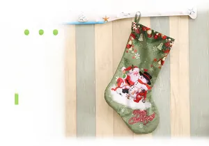 Detailed close-up of green linen texture Christmas stocking with Santa print