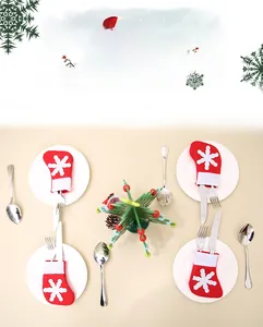 Close-up of festive red mini Christmas stocking silver holder with white snowflake pattern